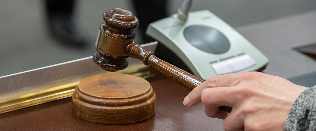 a board member reaching for the gavel