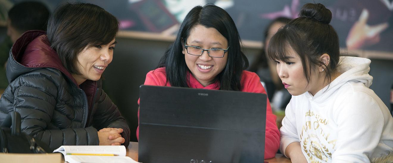 three students studying together